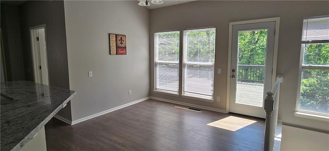 9201 N Harrison St, Kansas City, MO 64155 - unfurnished dining area featuring dark wood finished floors, plenty of natural light, and baseboards