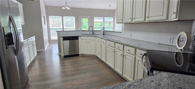 9201 N Harrison St, Kansas City, MO 64155 - kitchen with stainless steel appliances, a sink, dark wood-style flooring, white cabinets, and backsplash