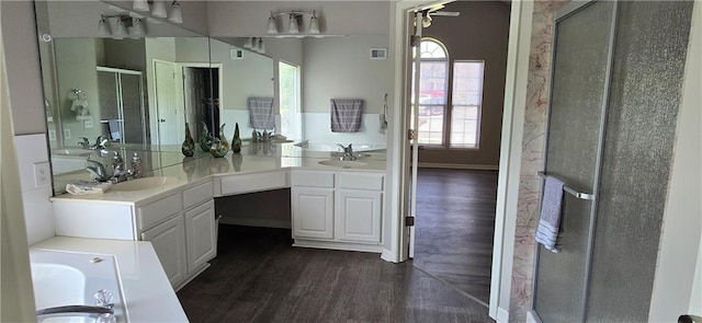 9201 N Harrison St, Kansas City, MO 64155 - bathroom featuring a stall shower, wood finished floors, vanity, and a tub to relax in