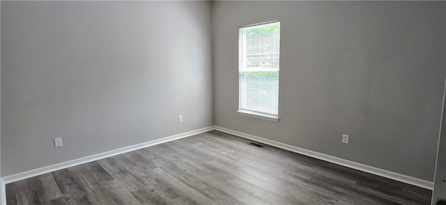 9201 N Harrison St, Kansas City, MO 64155 - spare room with dark wood-style flooring and baseboards