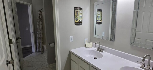 9201 N Harrison St, Kansas City, MO 64155 - bathroom with double vanity, marble finish flooring, and shower / bathtub combination with curtain