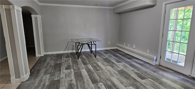9201 N Harrison St, Kansas City, MO 64155 - unfurnished dining area with arched walkways, wood finished floors, ornamental molding, ornate columns, and baseboards