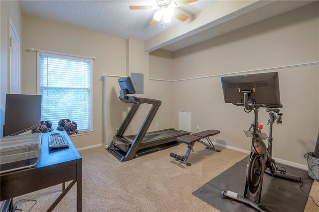exercise room with a ceiling fan, plenty of natural light, carpet floors, and baseboards