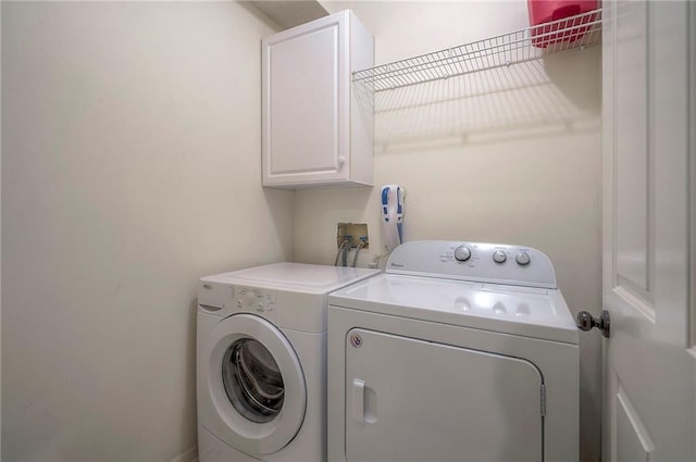 laundry area with cabinet space and washer and dryer