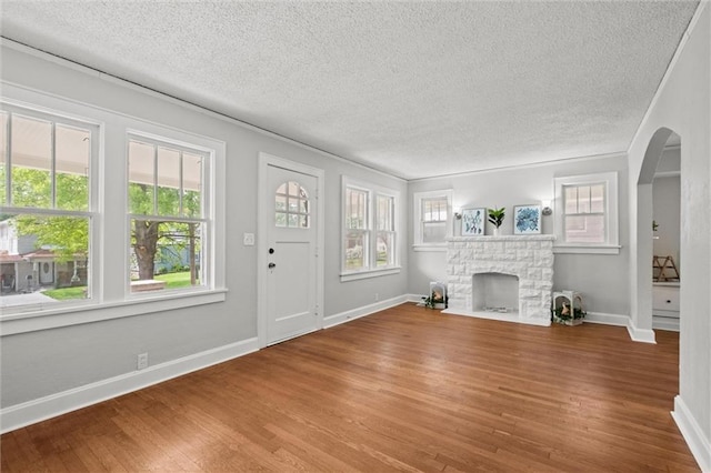 unfurnished living room featuring a textured ceiling and a wealth of natural light
