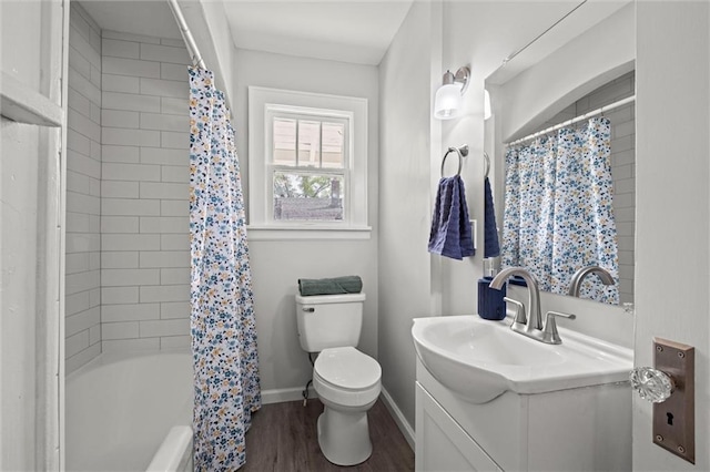 full bath featuring shower / bath combination with curtain, wood finished floors, vanity, baseboards, and toilet