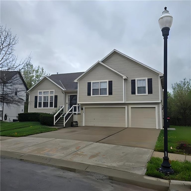 view of front facade featuring concrete driveway, a front lawn, and a garage