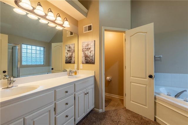 bathroom featuring a sink, a bath, and visible vents