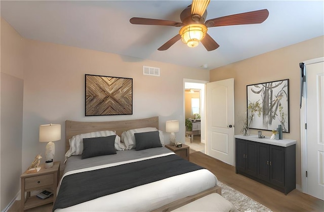 bedroom with baseboards, a ceiling fan, light wood-style flooring, and visible vents