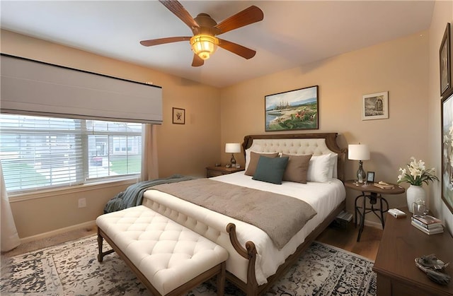 bedroom with baseboards and a ceiling fan