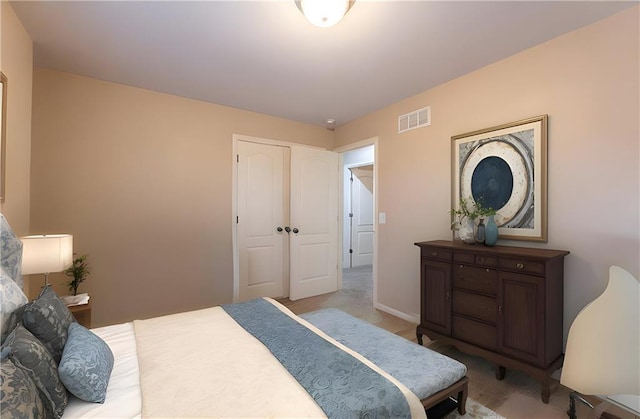 bedroom featuring baseboards and visible vents