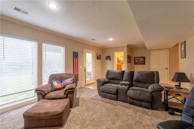 carpeted living area with crown molding, recessed lighting, and visible vents
