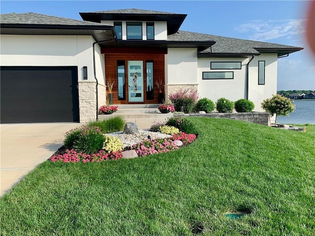 view of front of property featuring stone siding, an attached garage, and stucco siding