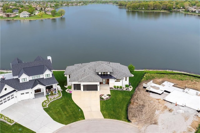 aerial view of property and surrounding area with a nearby body of water
