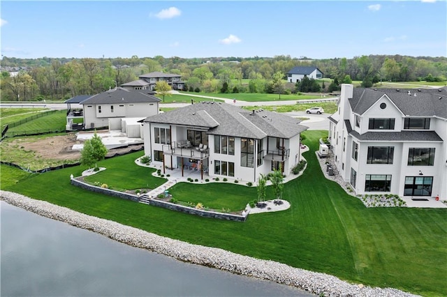 aerial view of property and surrounding area with a large body of water