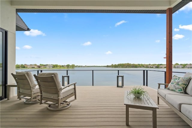 wooden terrace with a water view and an outdoor living space