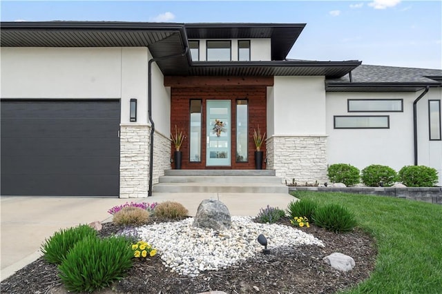 property entrance featuring stone siding, stucco siding, a garage, and driveway