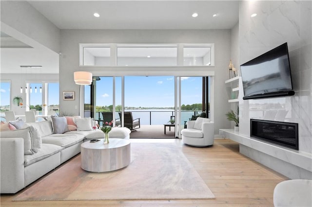 living area featuring hardwood / wood-style floors, a fireplace, and recessed lighting