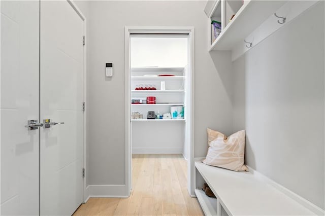mudroom featuring light wood-type flooring and baseboards