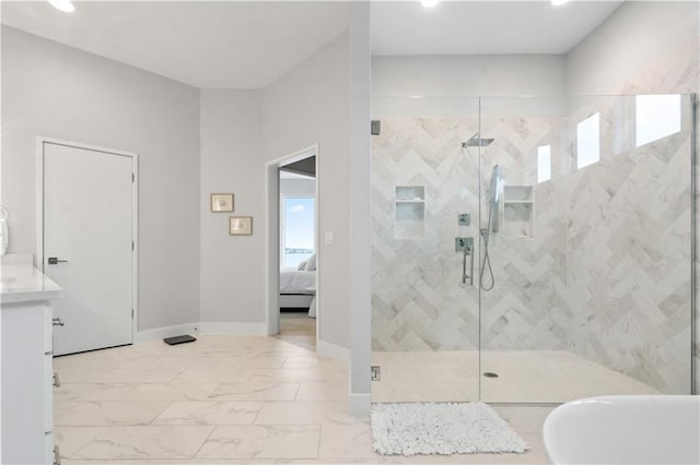 ensuite bathroom with a stall shower, recessed lighting, marble finish flooring, baseboards, and vanity