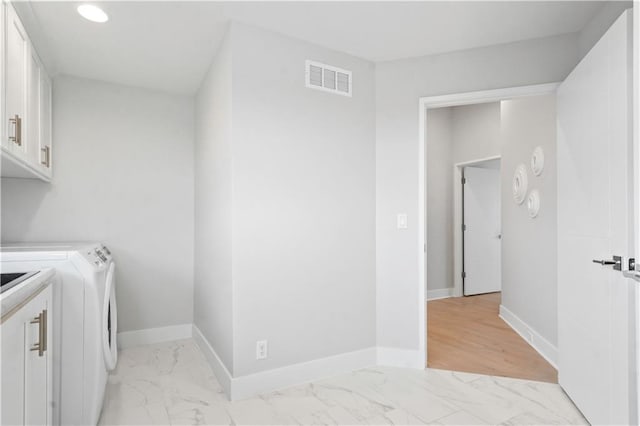 clothes washing area with cabinet space, washer and dryer, light marble finish flooring, baseboards, and recessed lighting