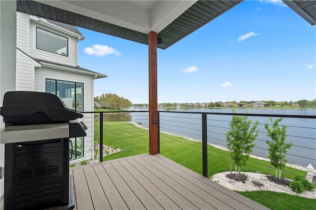 wooden deck featuring a water view and a lawn