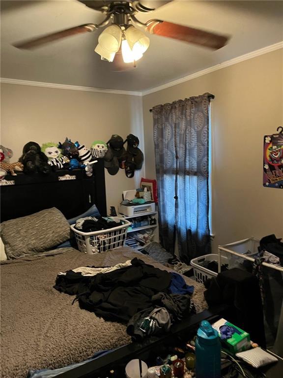 1114 Dakota St, Leavenworth, KS 66048 - carpeted bedroom featuring ornamental molding and a ceiling fan