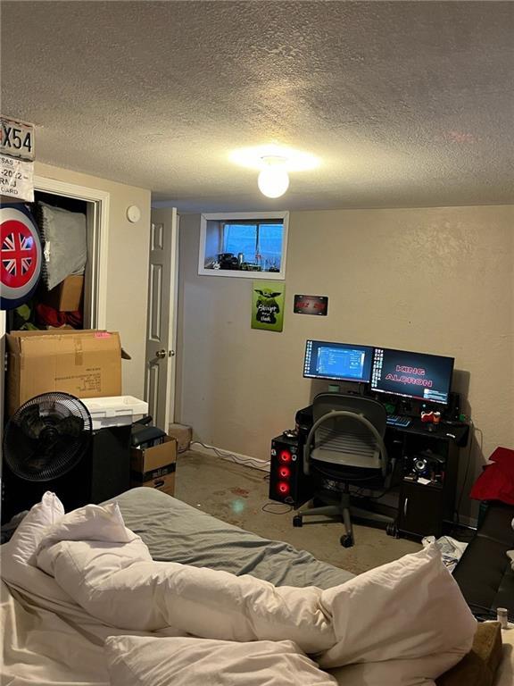 1114 Dakota St, Leavenworth, KS 66048 - bedroom with concrete floors and a textured ceiling