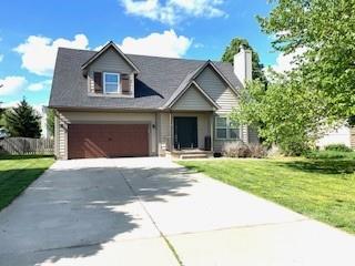 view of front facade with a garage, a front yard, and concrete driveway