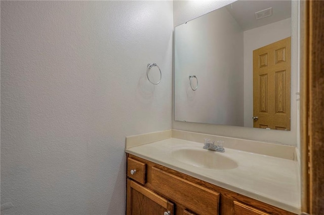 bathroom with visible vents and vanity