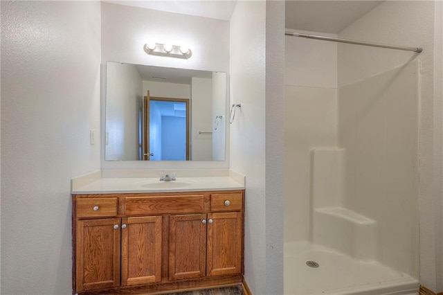 bathroom with vanity and walk in shower