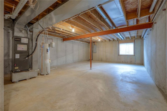 basement featuring heating unit, electric panel, and electric water heater