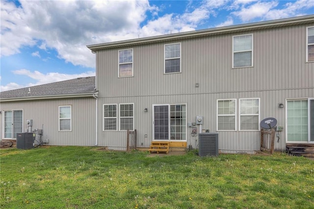 back of property featuring a lawn, cooling unit, and entry steps