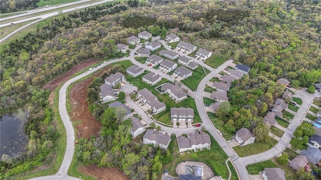 drone / aerial view featuring a water view and a residential view
