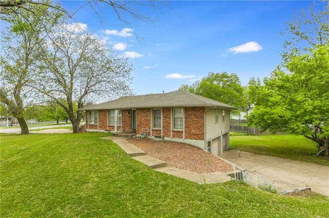 ranch-style house featuring a garage, brick siding, fence, a front lawn, and concrete driveway