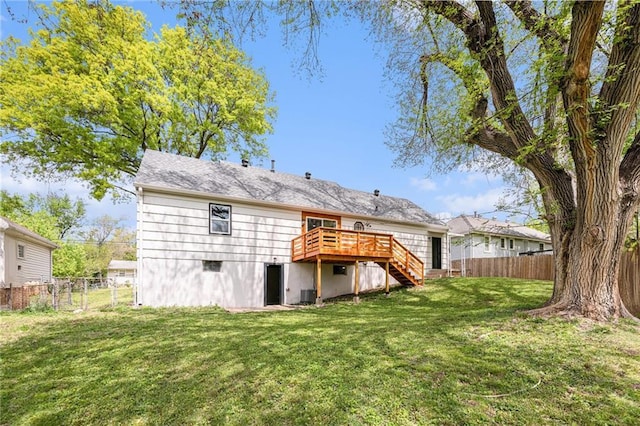 9505 E 79th St, Raytown, MO 64138 - back of property with a fenced backyard, stairway, a wooden deck, cooling unit, and a lawn