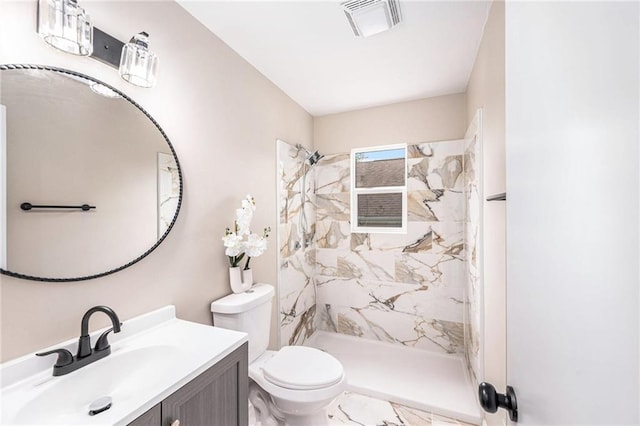 9505 E 79th St, Raytown, MO 64138 - bathroom featuring visible vents, toilet, vanity, and a tile shower