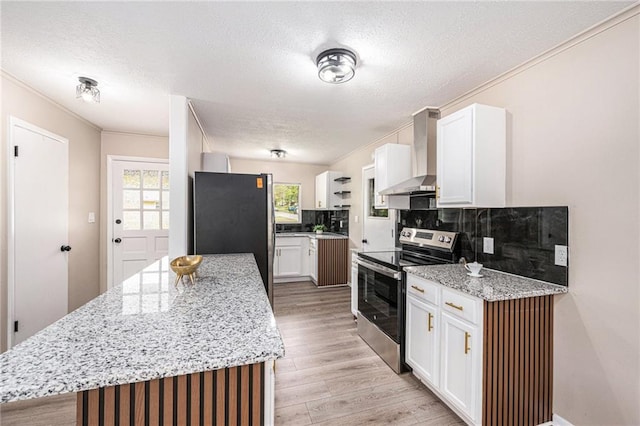 9505 E 79th St, Raytown, MO 64138 - kitchen with tasteful backsplash, wall chimney exhaust hood, appliances with stainless steel finishes, ornamental molding, and a textured ceiling