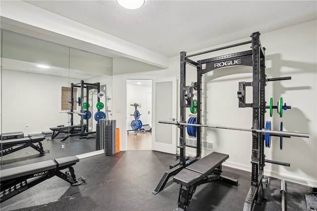 workout room with baseboards