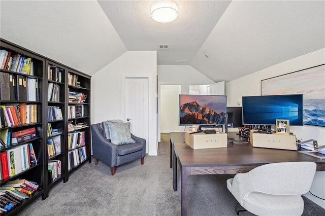 office featuring carpet flooring, visible vents, and vaulted ceiling