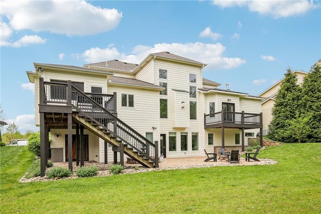 back of house featuring stairway, a patio area, an outdoor fire pit, a lawn, and a deck