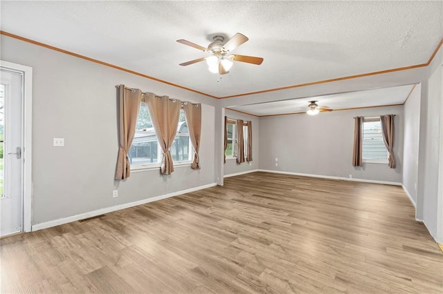 unfurnished room featuring baseboards, light wood-type flooring, ornamental molding, and a ceiling fan