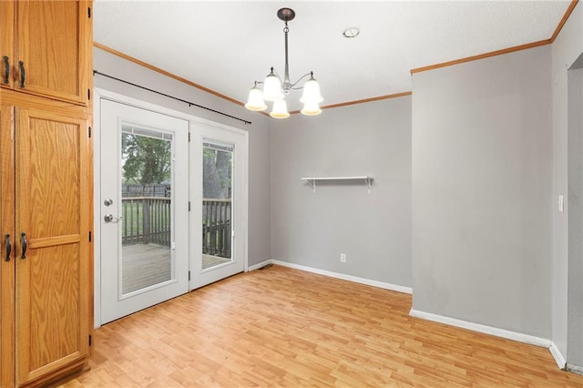 unfurnished dining area with baseboards, light wood-type flooring, an inviting chandelier, and crown molding