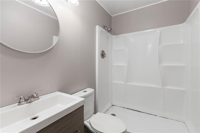 bathroom featuring toilet, walk in shower, and vanity