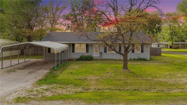 view of front of property with a front lawn, driveway, and a detached carport