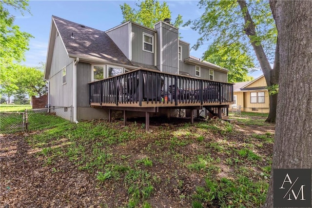 1708 NW Ashton Dr, Blue Springs, MO 64015 - rear view of property featuring a chimney, a shingled roof, fence, and a deck