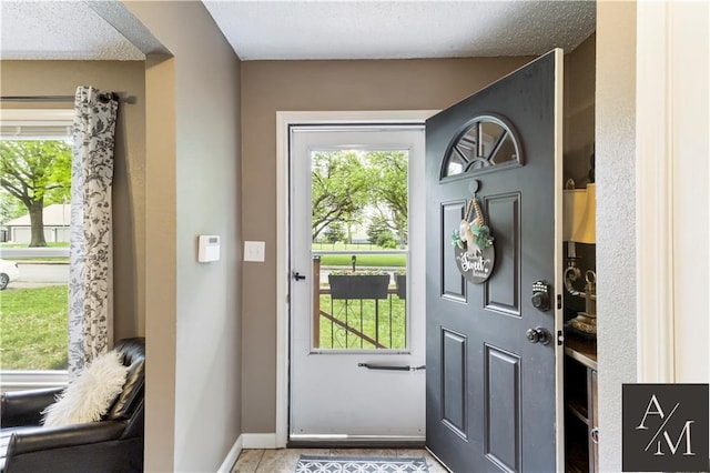 1708 NW Ashton Dr, Blue Springs, MO 64015 - entryway with a textured ceiling, baseboards, and light tile patterned floors