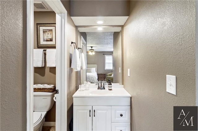 1708 NW Ashton Dr, Blue Springs, MO 64015 - ensuite bathroom featuring visible vents, vanity, toilet, connected bathroom, and a textured wall
