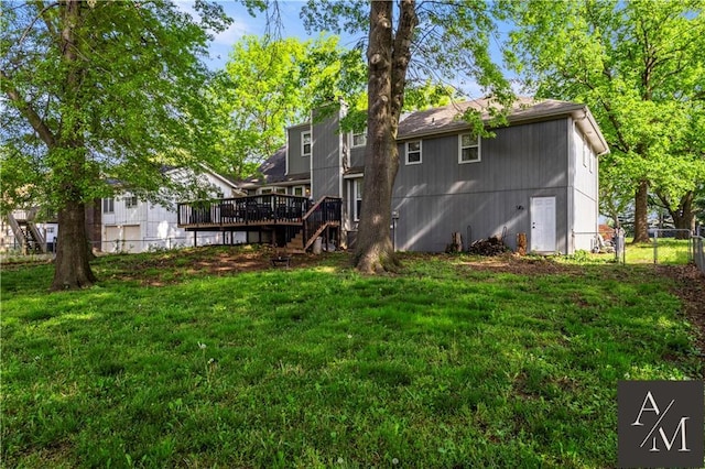 1708 NW Ashton Dr, Blue Springs, MO 64015 - rear view of property with a wooden deck, fence, a chimney, a yard, and stairway