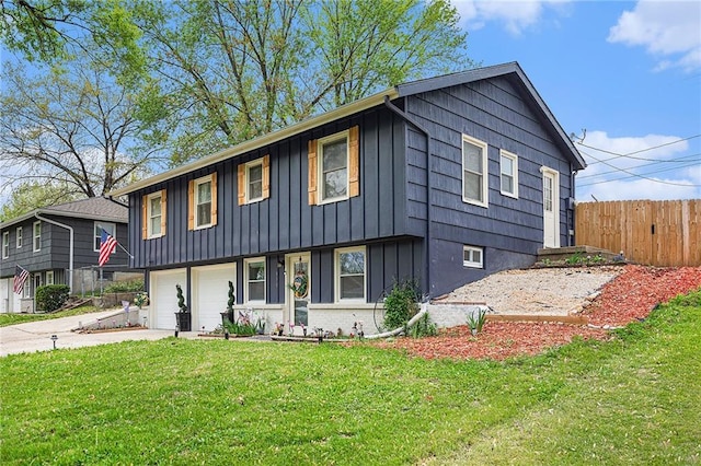 view of front facade with fence, driveway, board and batten siding, and a front yard